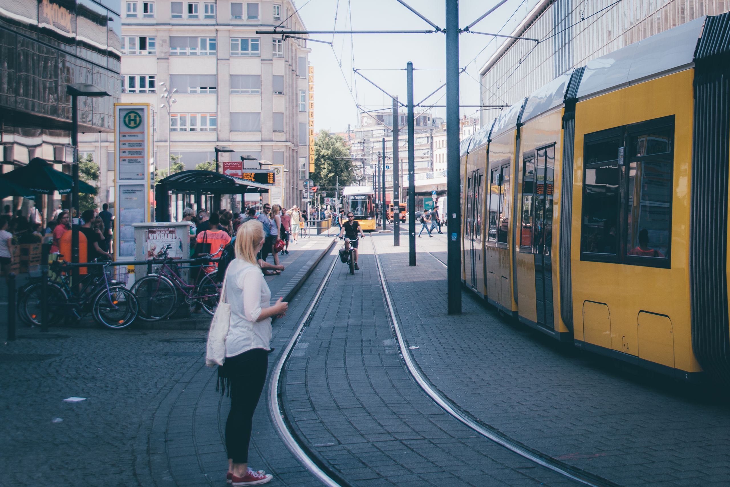 side-view-woman-standing-street-by-tramway